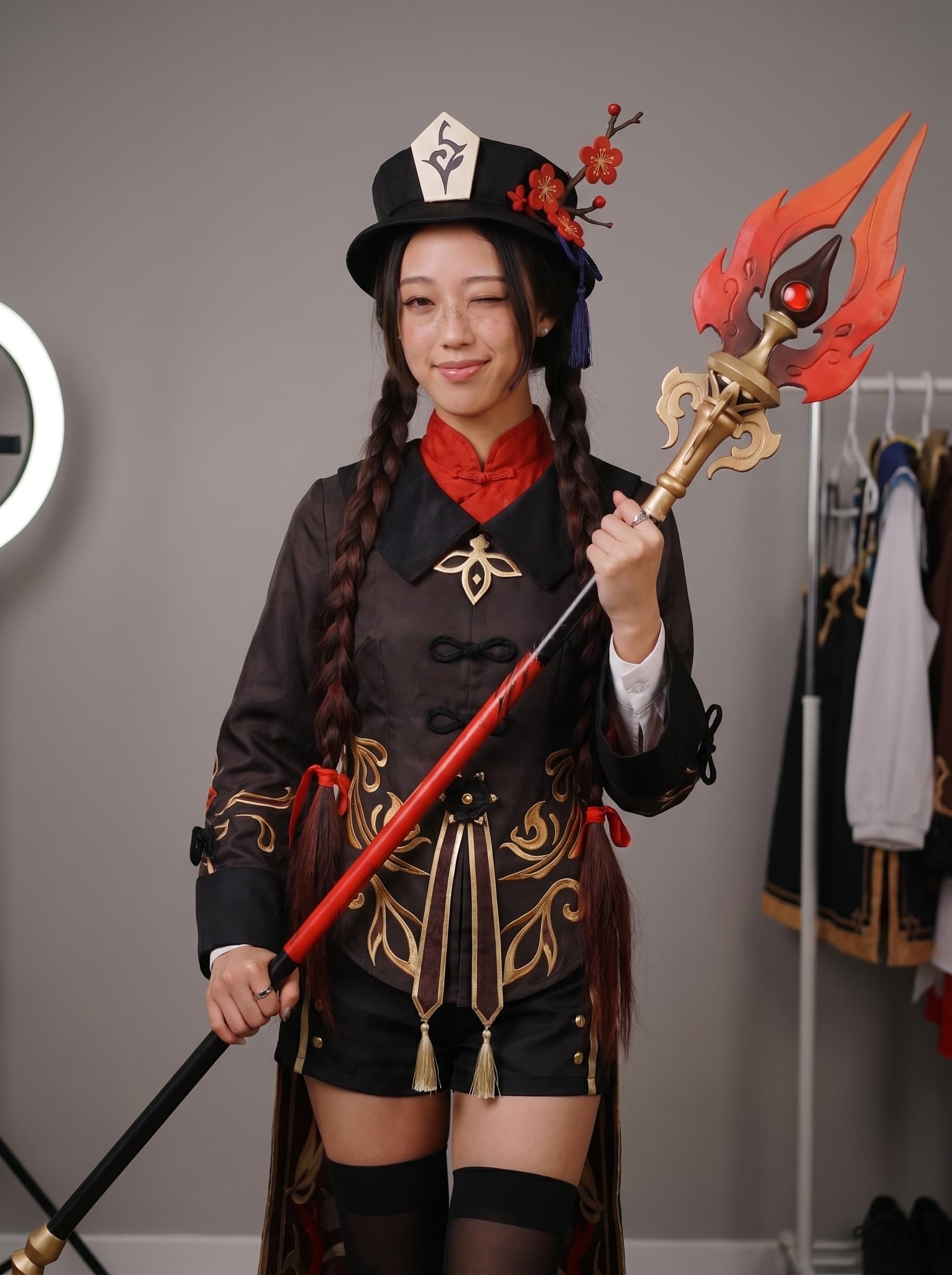 hu tao cosplay portrait, plum blossom hat, mischievous look